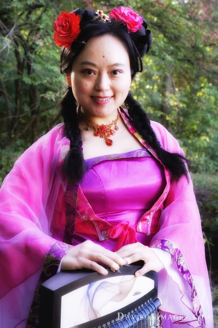 UlanWay Emay in traditional dress holding a guzheng