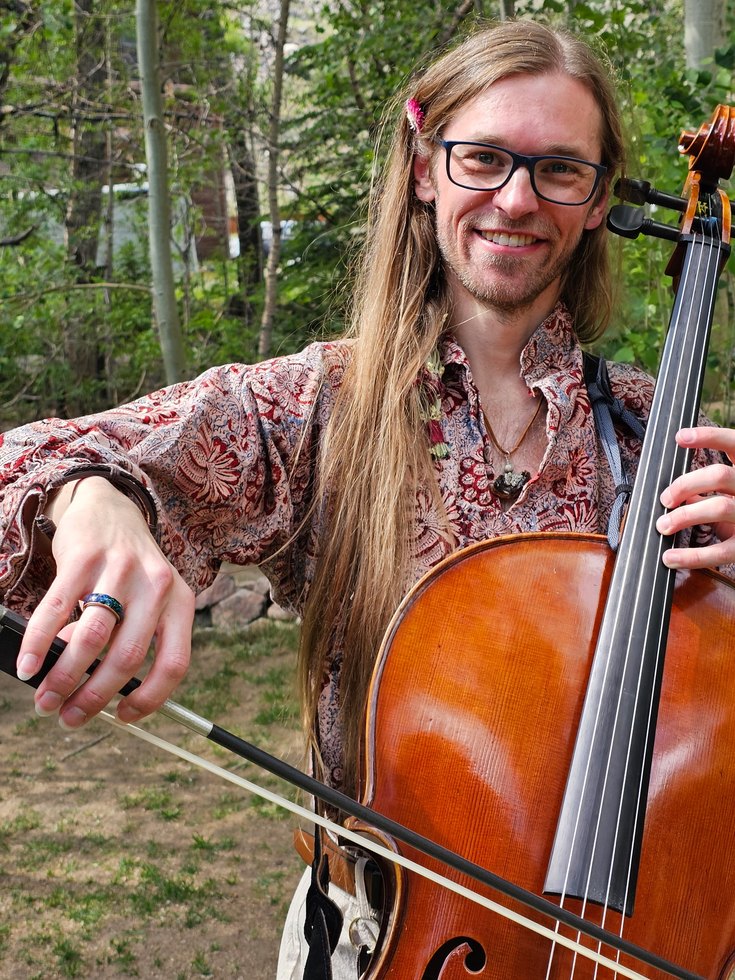 Brian Grimm holding a cello