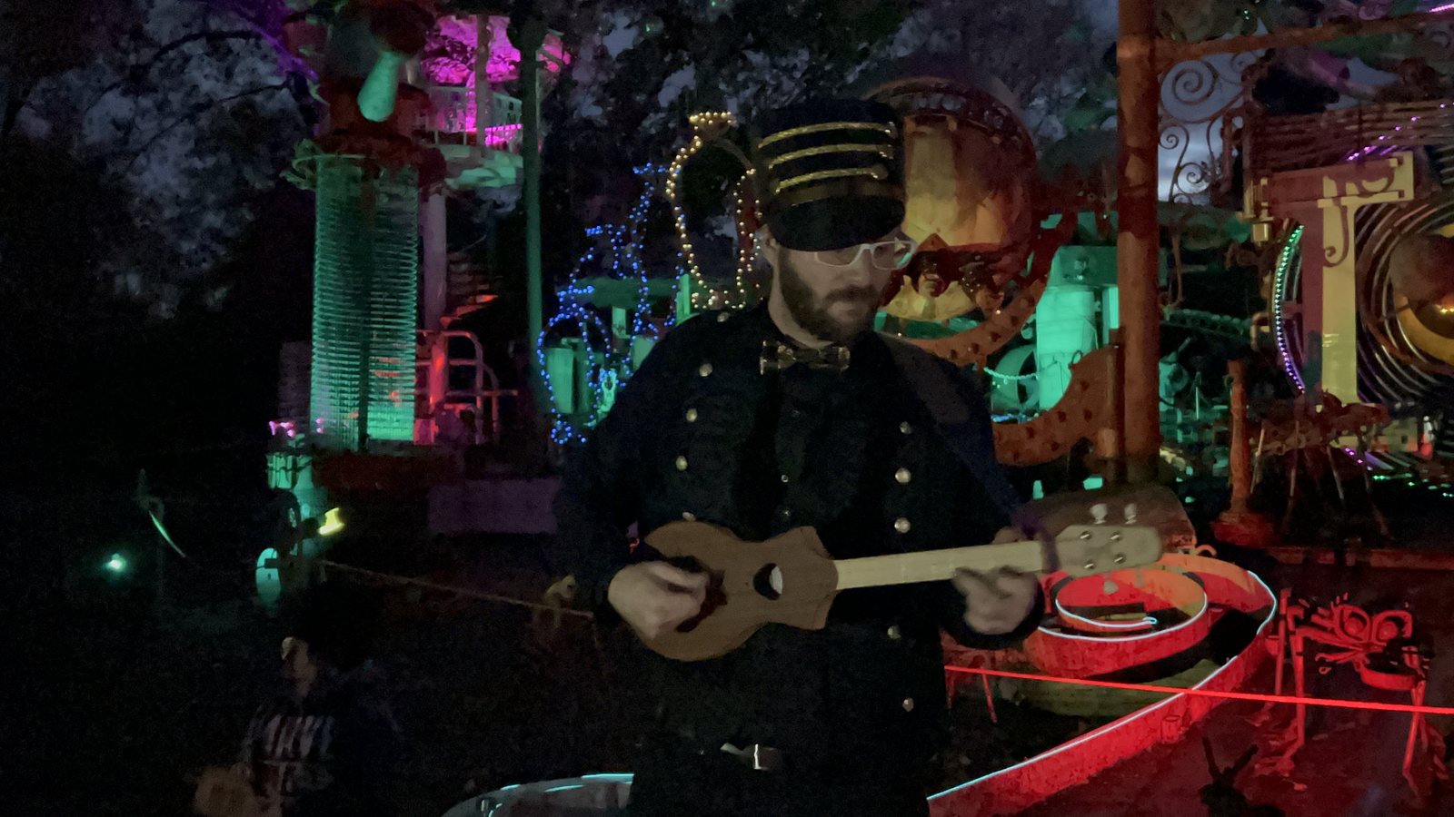 Vardo performing at night among colorful stage lights